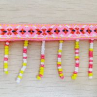 jacquard ribbon with pink yellow white bead fringe