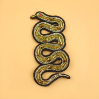 golden embroidered snake patch with beads and chain